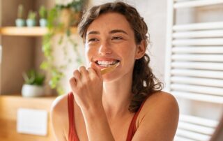 woman brushing teeth.